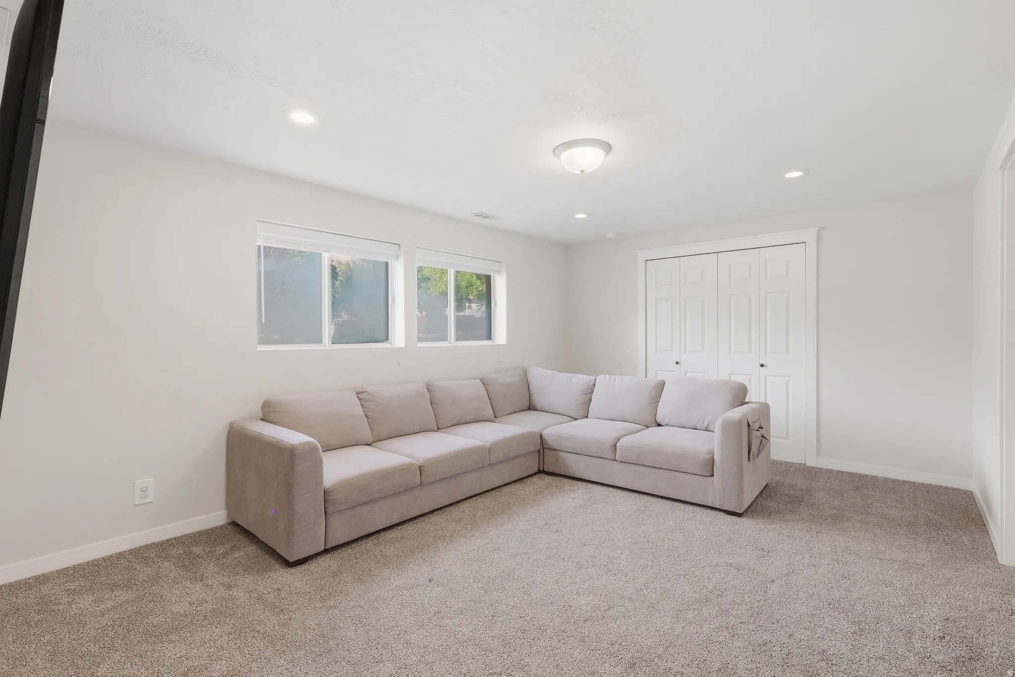 Plush carpeting, recessed lighting, double-pane windows, and a built-in closet with bi-fold doors