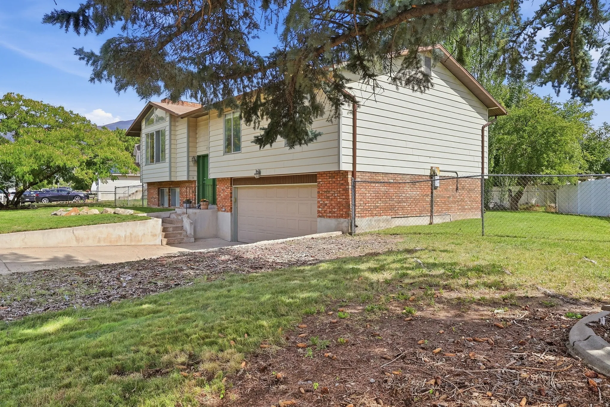 Split-level residence featuring a brick foundation and siding exterior