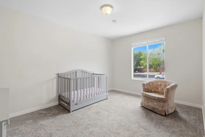 Carpeted room with a double-pane window and a flush-mount ceiling light