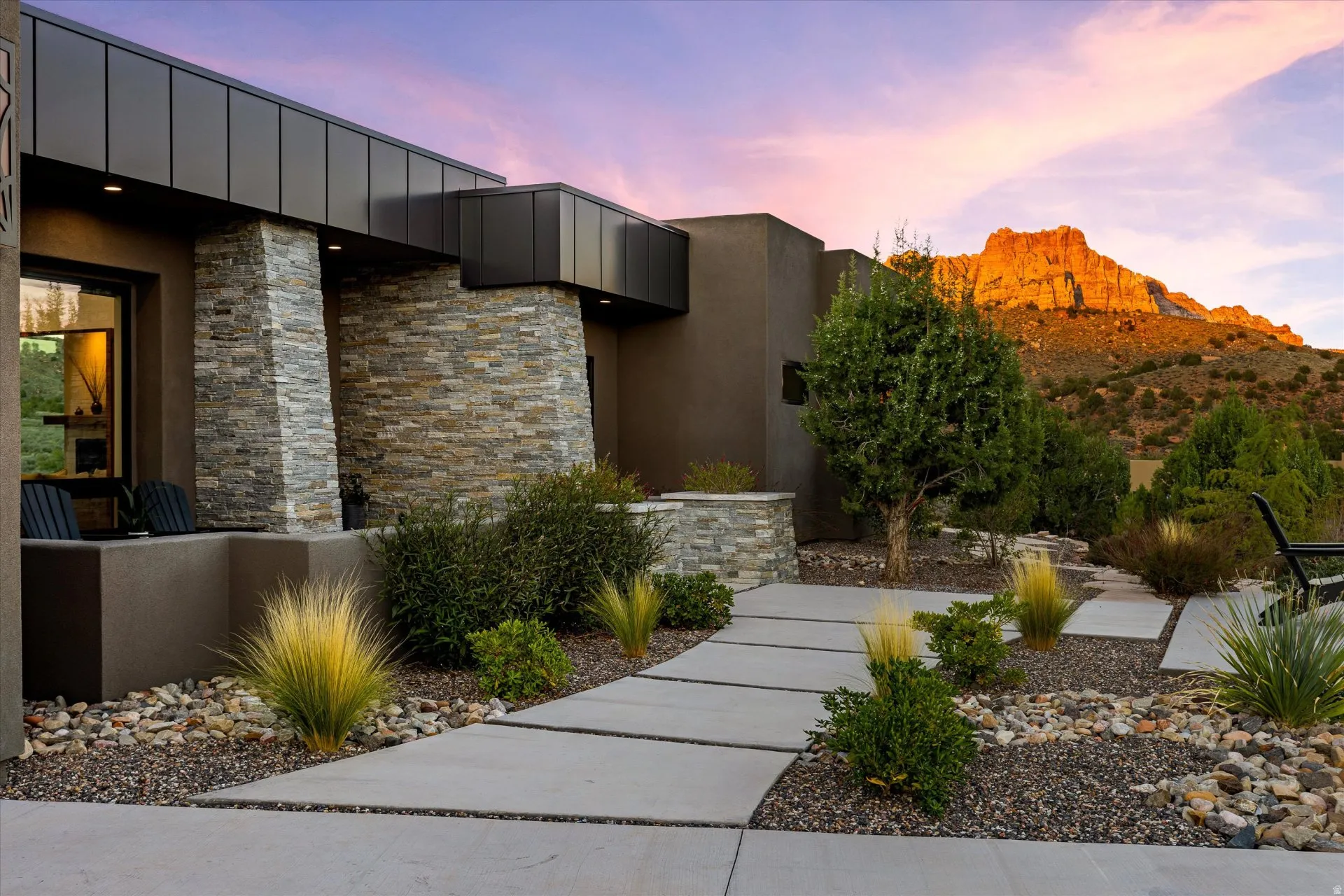 Stone pathways and desert plantings lead to the entry, welcoming you home.