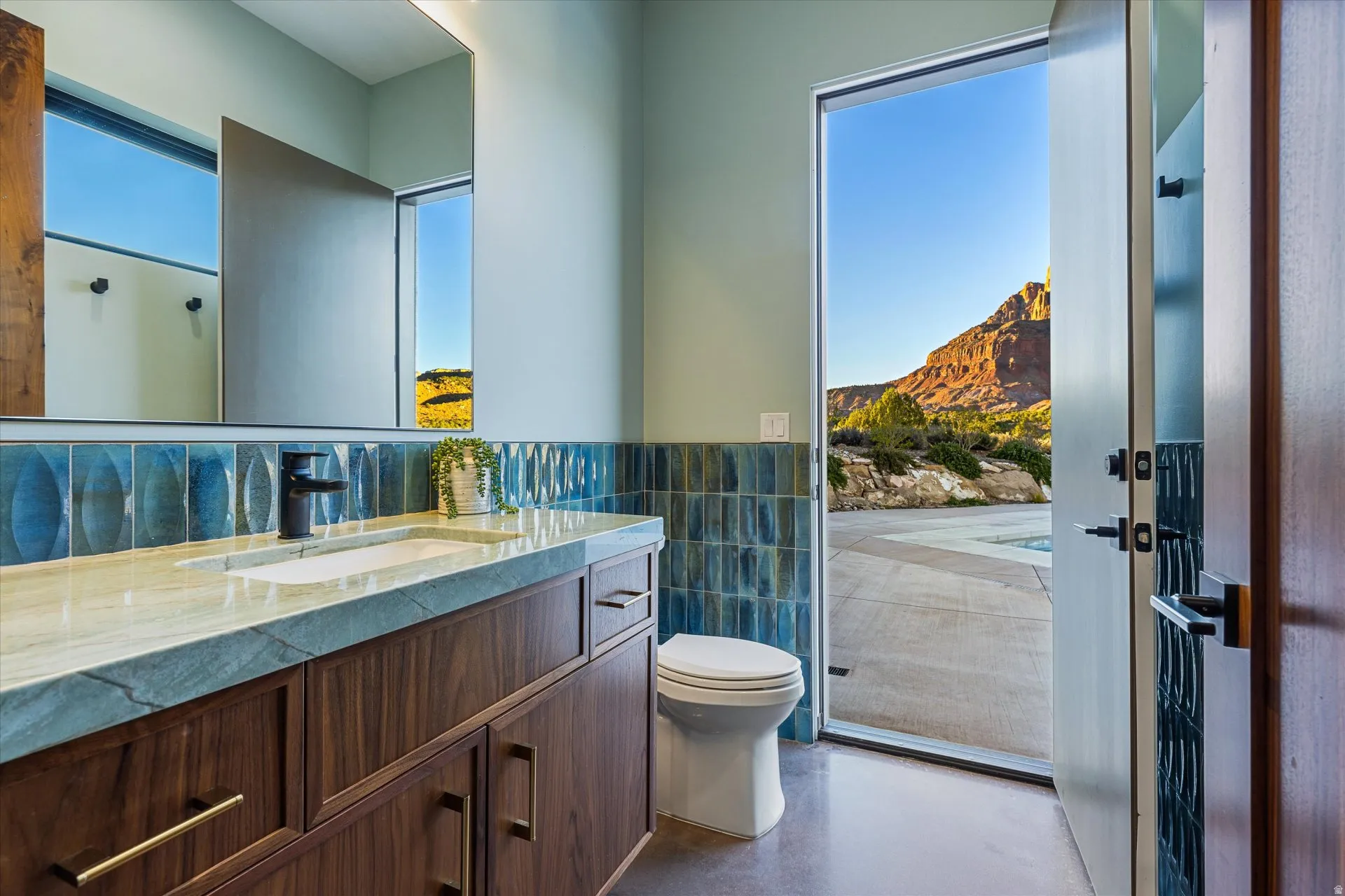 Half bath attached to the bedroom (home gym), with direct access to the pool patio and outdoor shower.