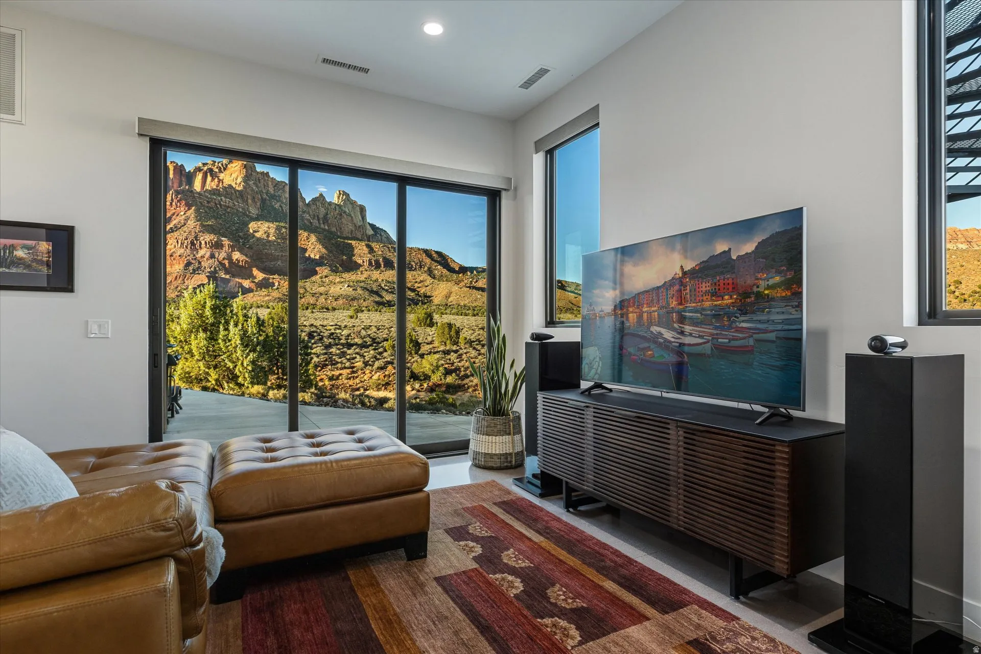 The Guest Suite's living room, complete with a TV wall and a slider out to the pool patio. (Sonos system conveys)