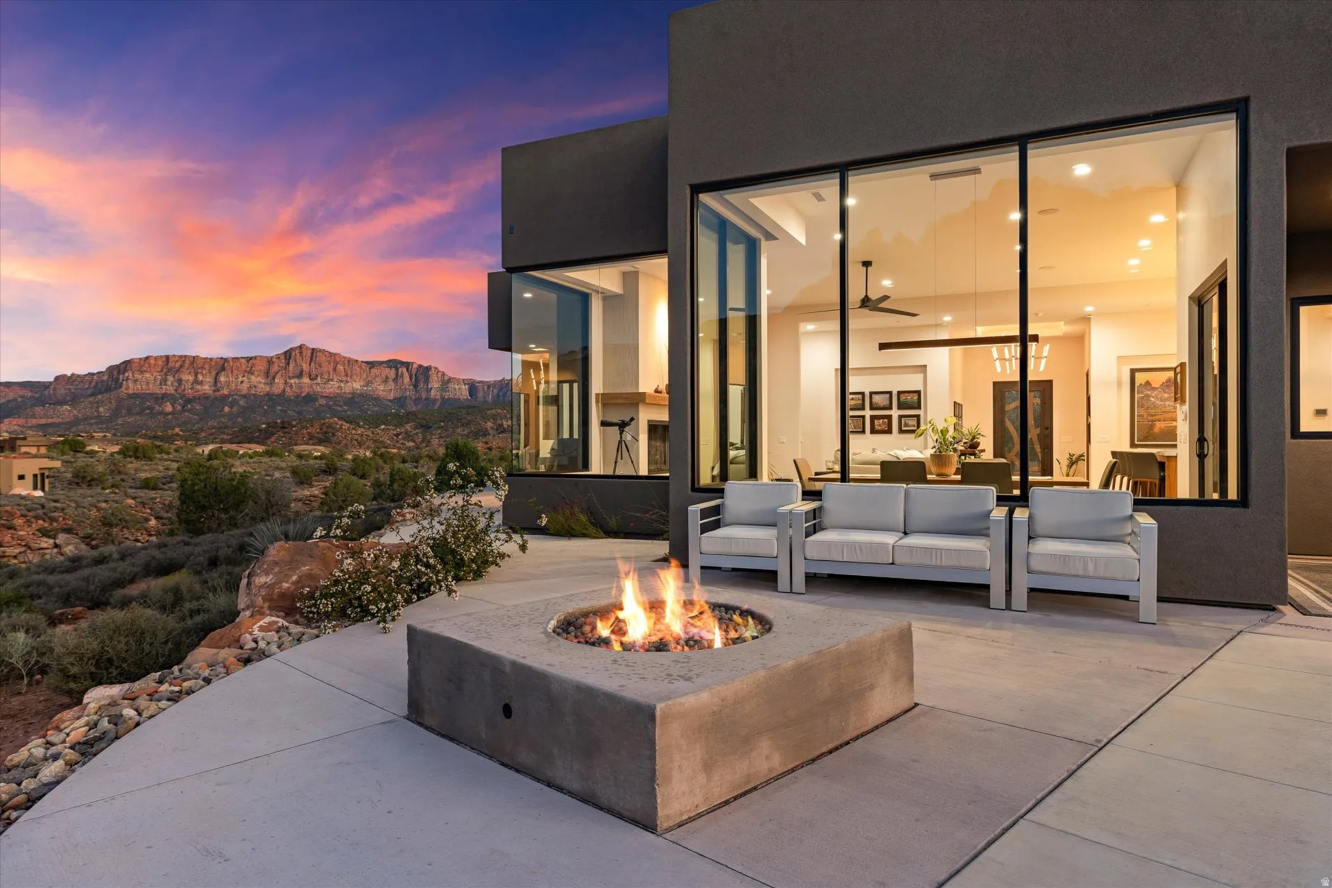 The back patio's gas fire pit sits just off the sliding glass doors, blending indoor and outdoor living.