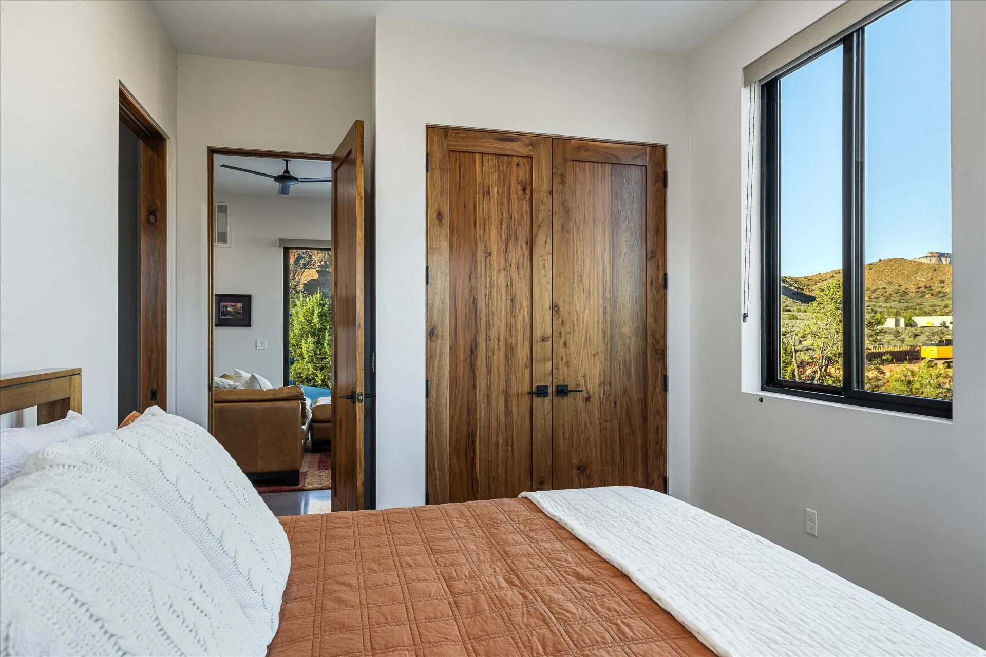 A guest bedroom with a closet and direct access to its ensuite bath.