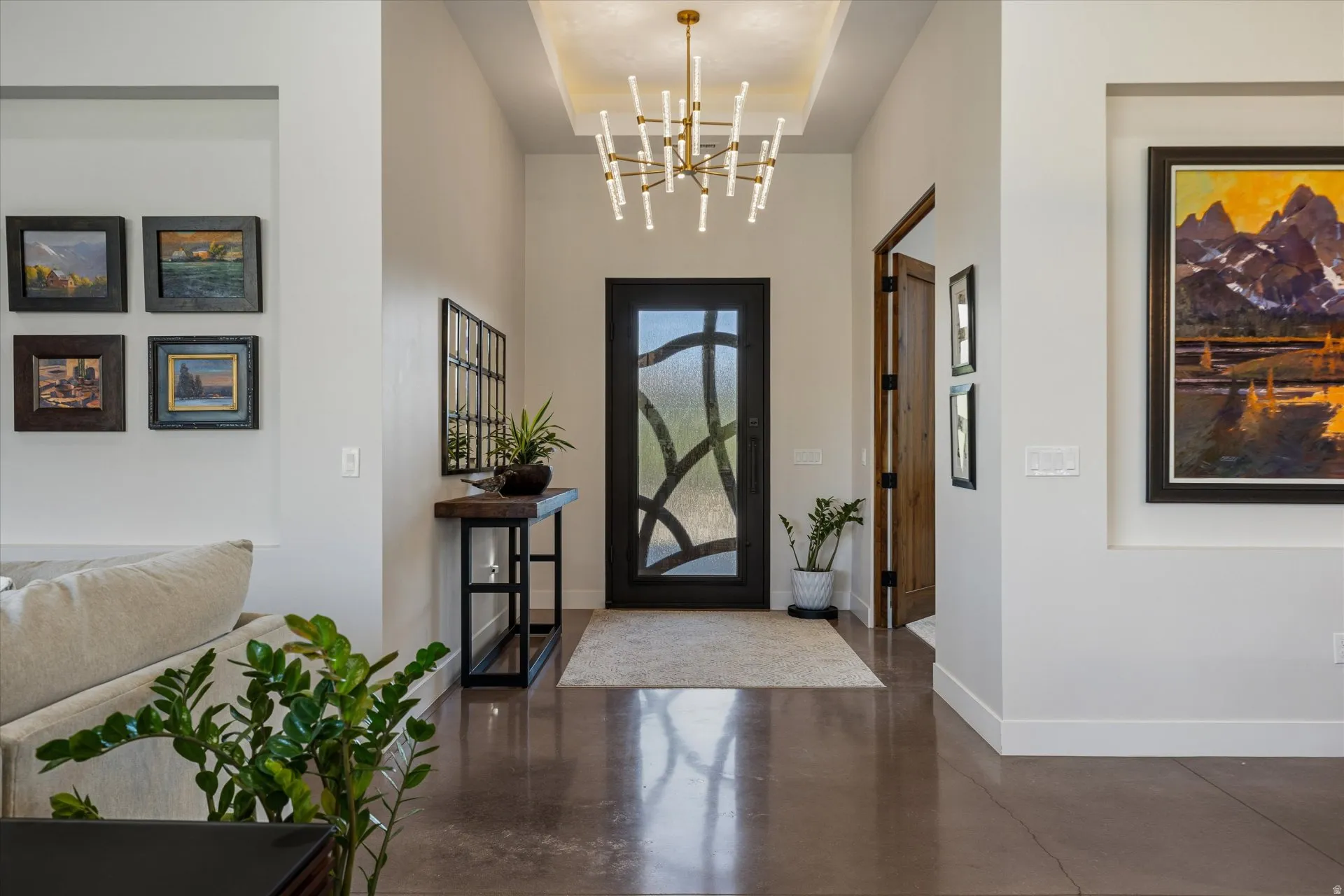 Step through the front door to a designer chandelier, warm lighting, and an inviting entry hall.