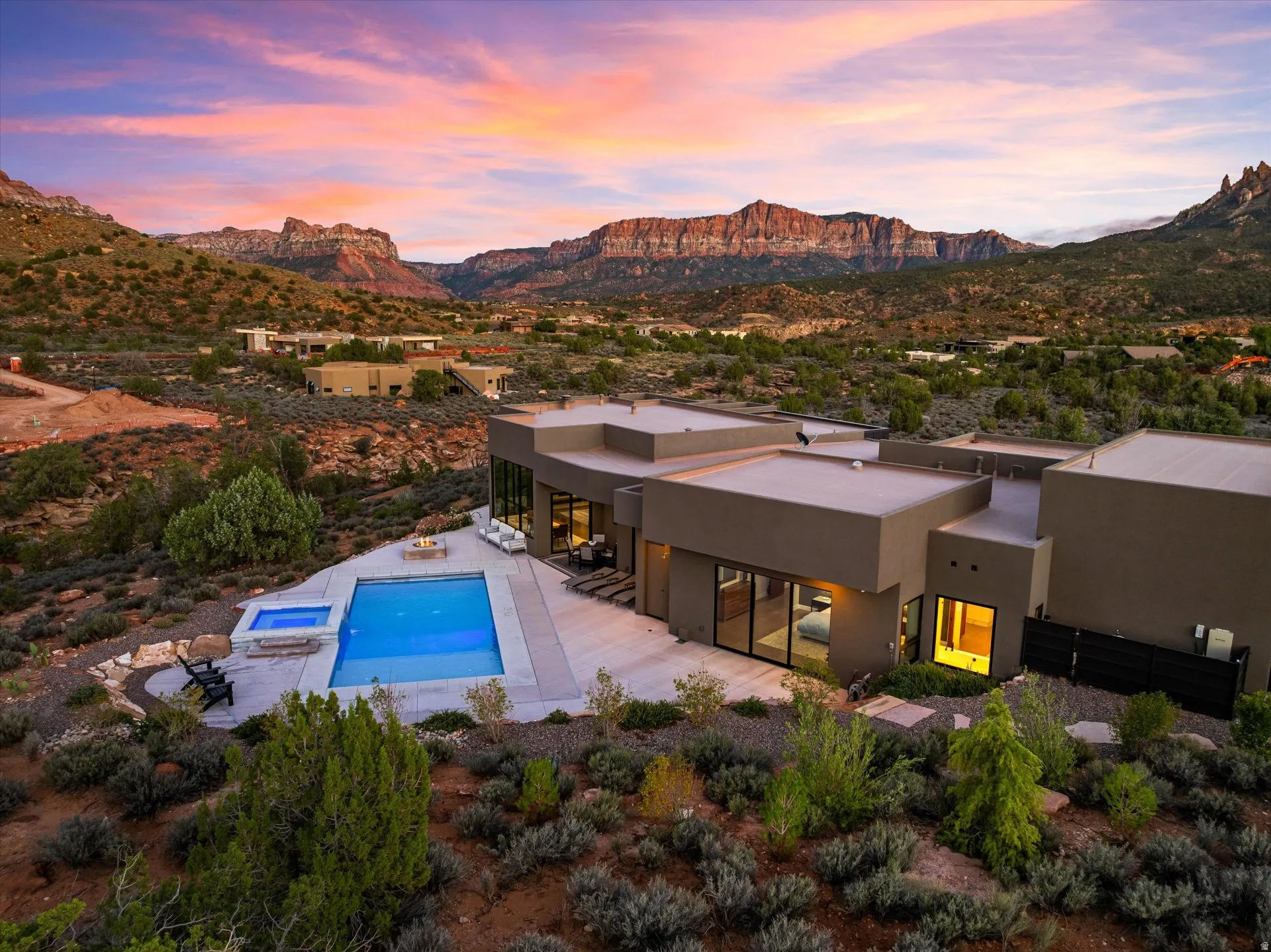 Twilight settles over the heated saltwater pool and patio, where indoor and outdoor living blur together.