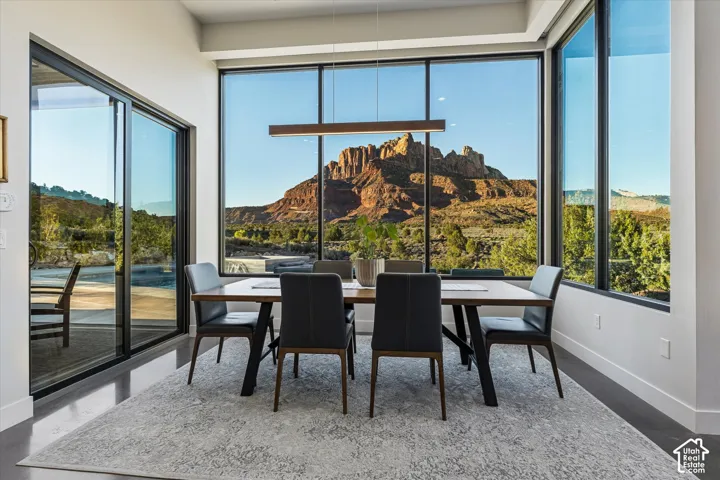 A dining space with wraparound windows turns every meal into a view of Mt. Kinesava.