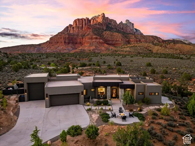 Full property, showcasing the extra-large 2-car garage plus a separate oversized RV/boat bay, with Mt. Kinesava framing the view.