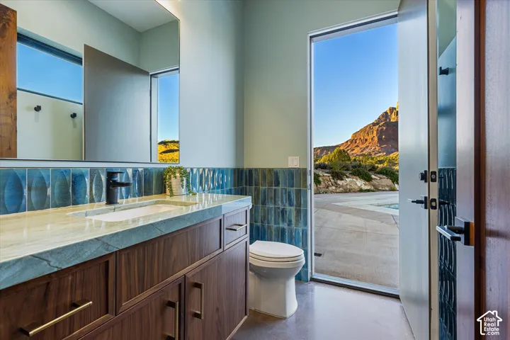 Half bath attached to the bedroom (home gym), with direct access to the pool patio and outdoor shower.