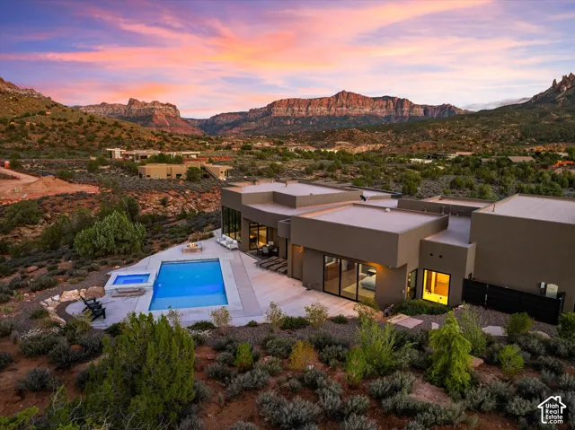 Twilight settles over the heated saltwater pool and patio, where indoor and outdoor living blur together.