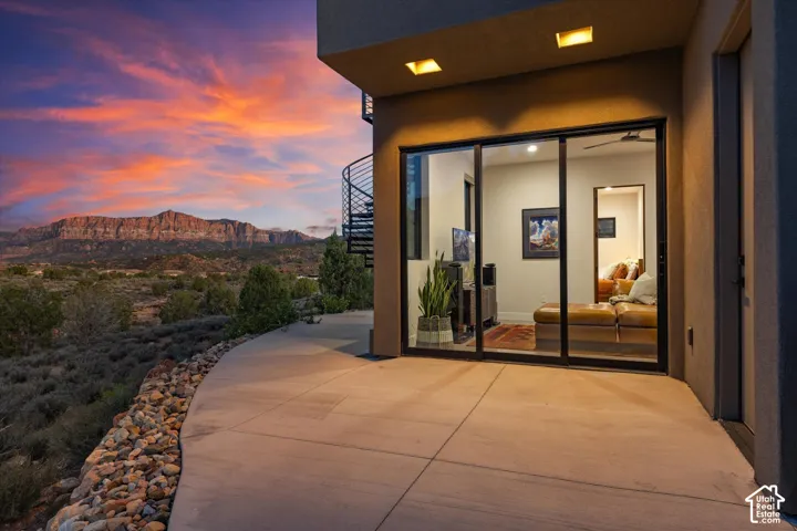 The guest wing opens directly onto the pool patio, framed by views of The Watchman and Mt. Kinesava.