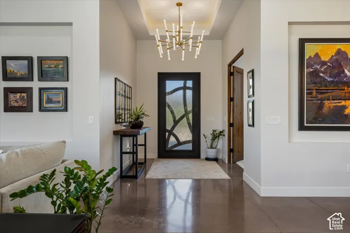Step through the front door to a designer chandelier, warm lighting, and an inviting entry hall.