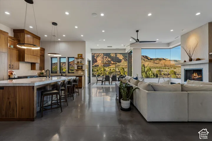The kitchen opens directly into the living space, with a walnut feature wall and polished concrete floors.