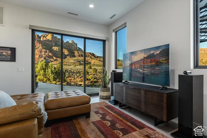 The Guest Suite's living room, complete with a TV wall and a slider out to the pool patio. (Sonos system conveys)