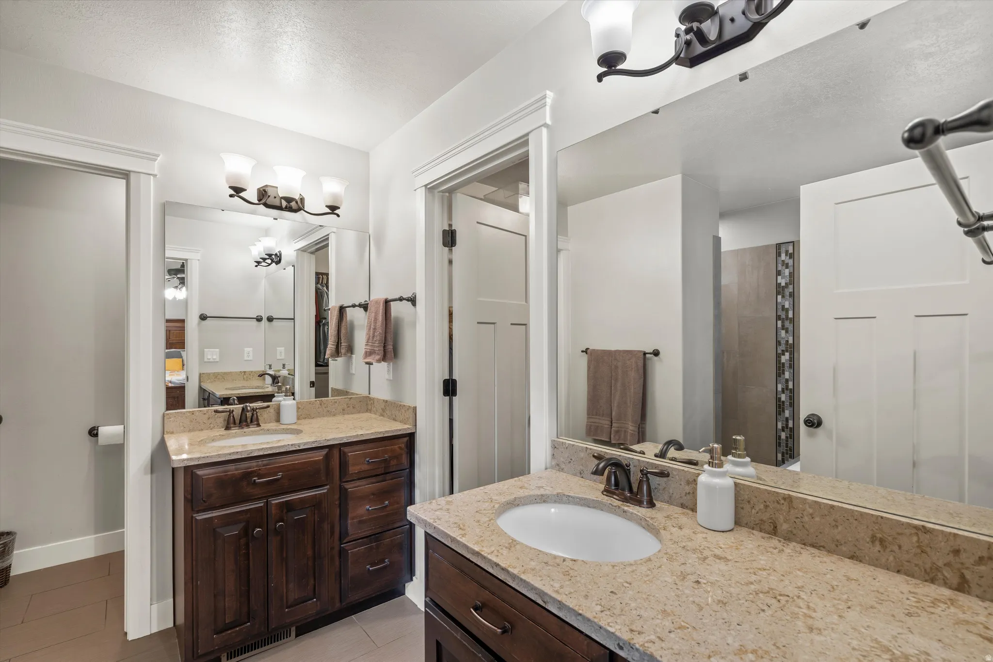 Dual vanity with individual sinks and stone countertops
