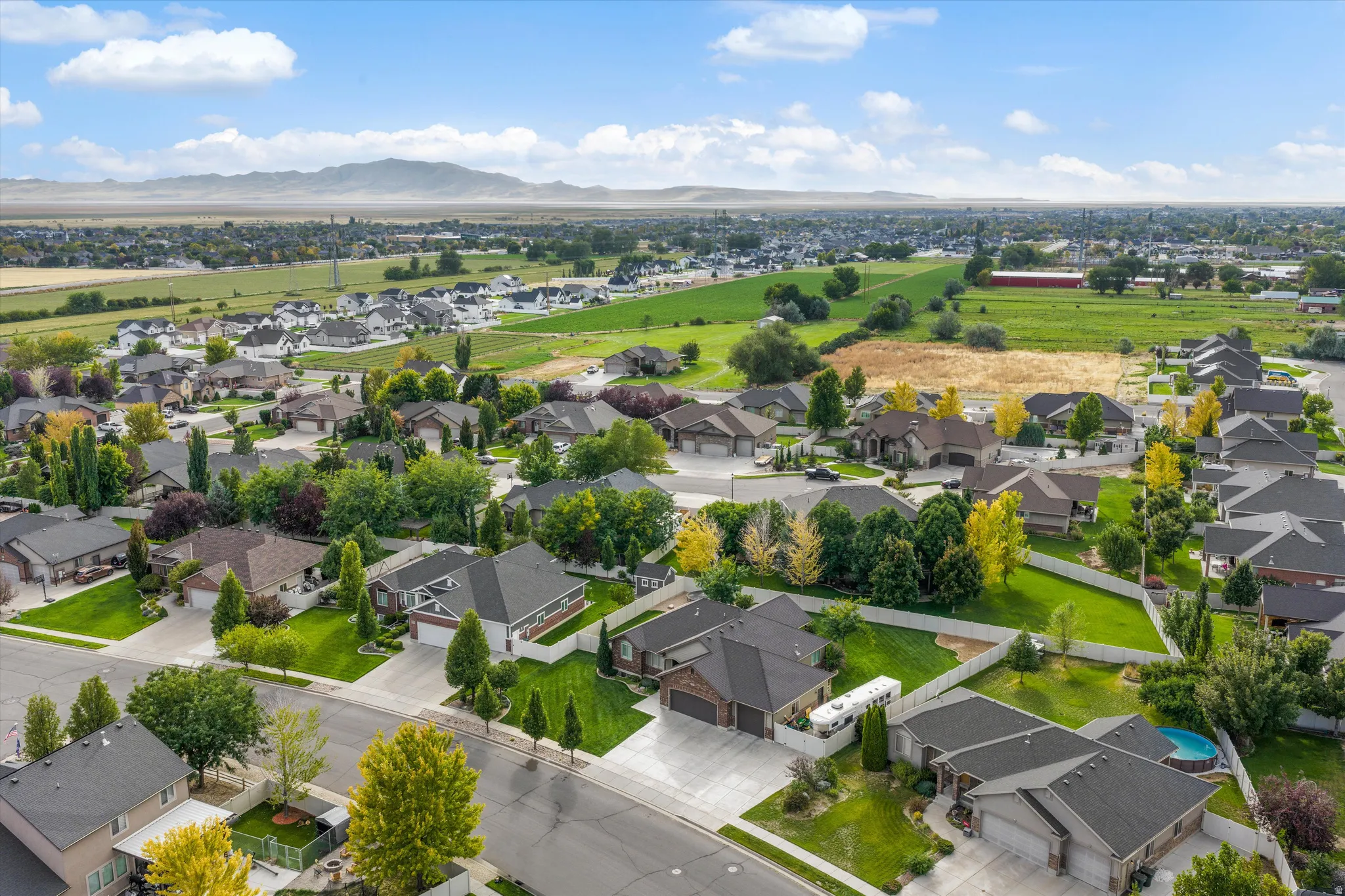 Expansive neighborhood setting with established homes, green spaces, and mountain scenery