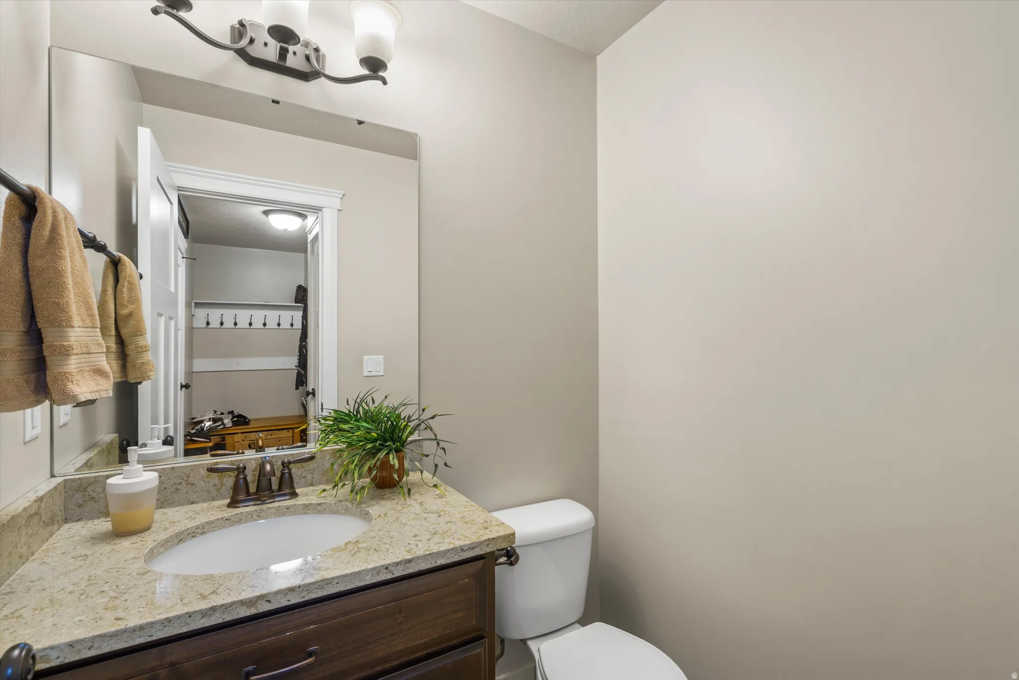 Vanity with an undermount sink, bronze-finish faucet, and granite-look countertop