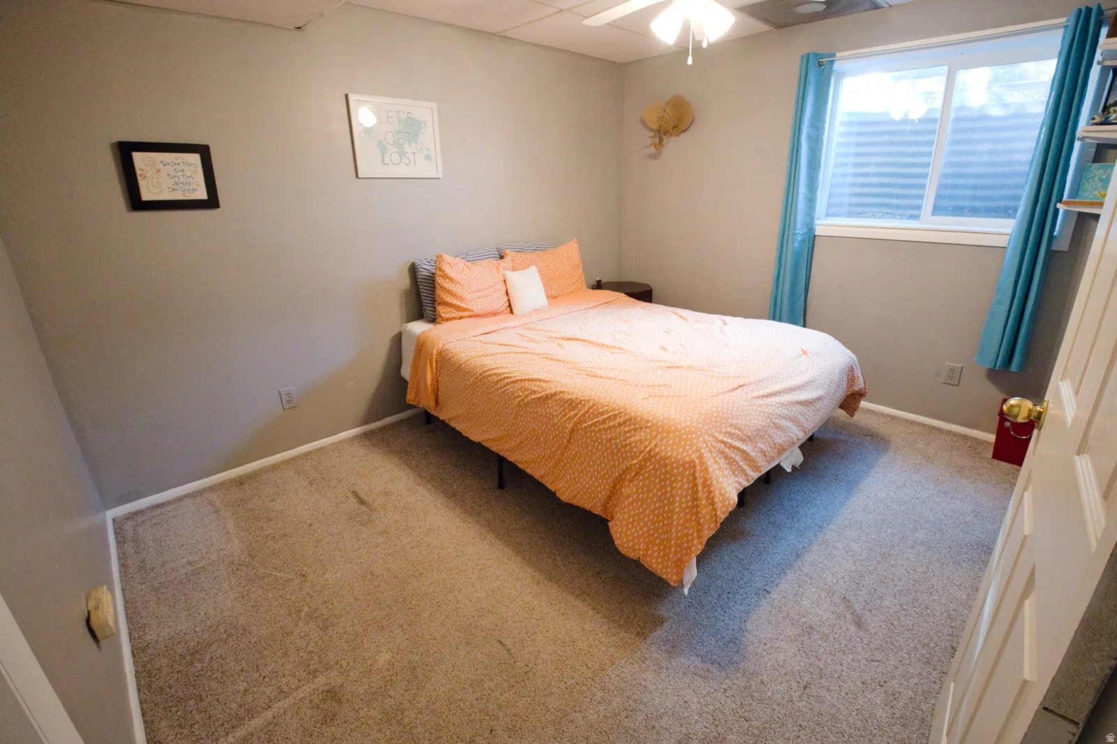 Wall-to-wall carpet flooring, neutral painted walls, ceiling fan, and a window with blinds
