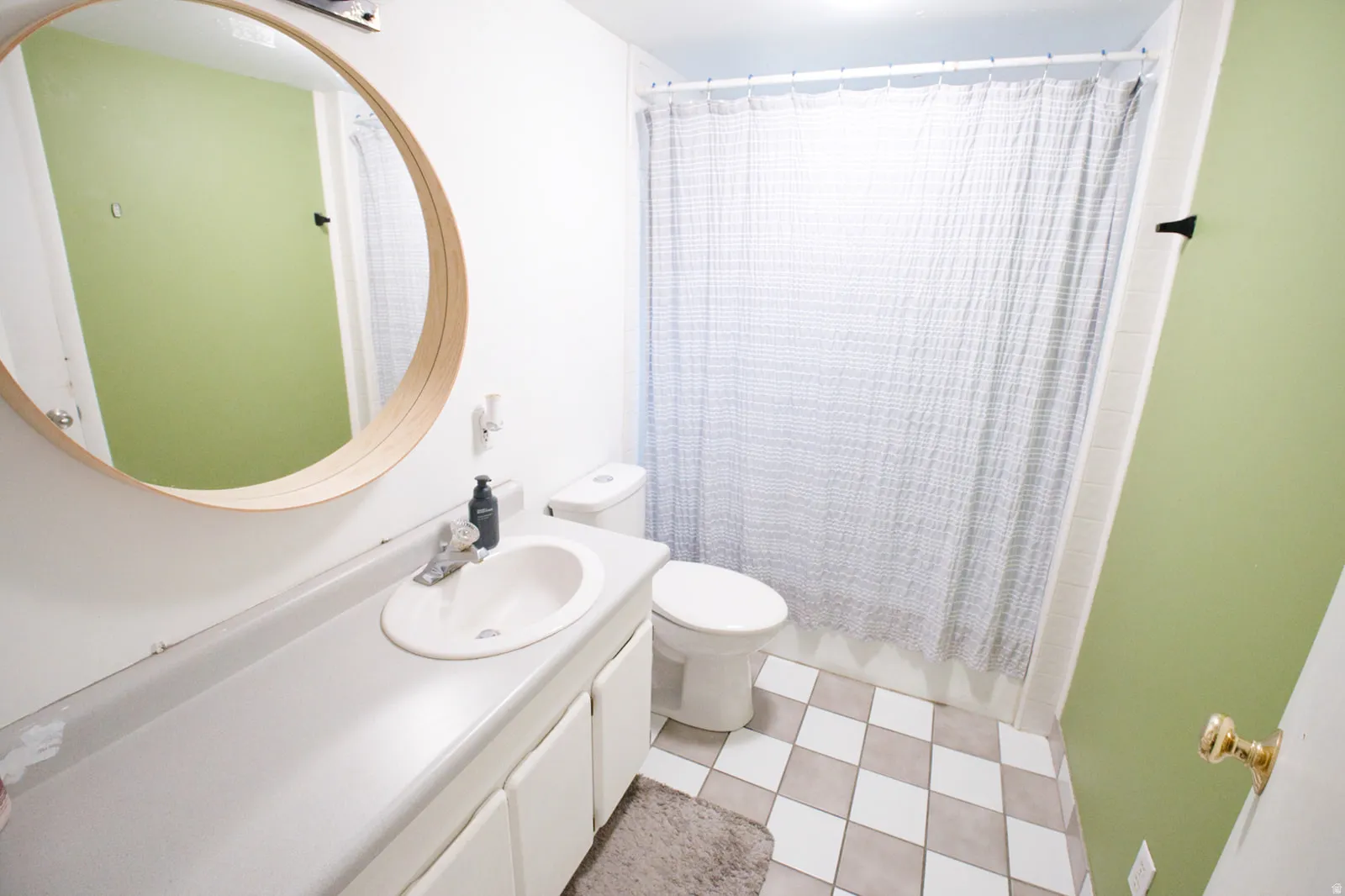 White vanity with an integrated sink and laminate countertop