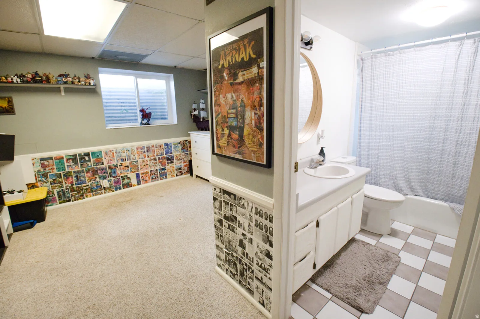 Bathroom featuring a white vanity with an integrated sink, a built-in bathtub with shower, and checkered floor tiling