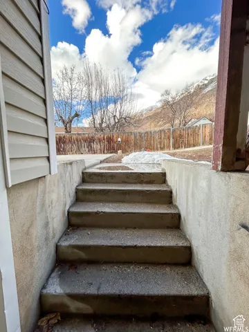 Concrete staircase leading to a fenced backyard