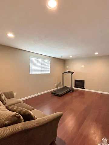 Recessed lighting, wood-finish flooring, and a built-in fireplace