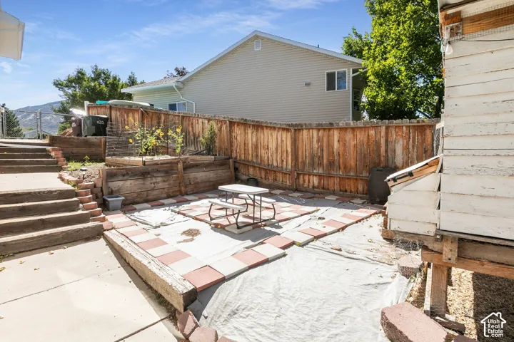 Tiered backyard with wood retaining walls and a wood fence