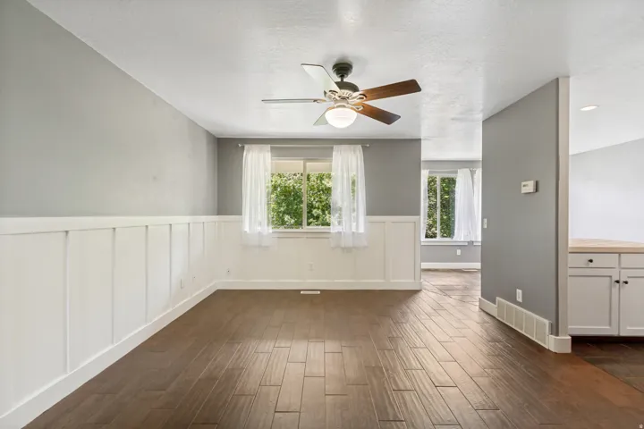 Wood-finish flooring with white board and batten wall treatment
