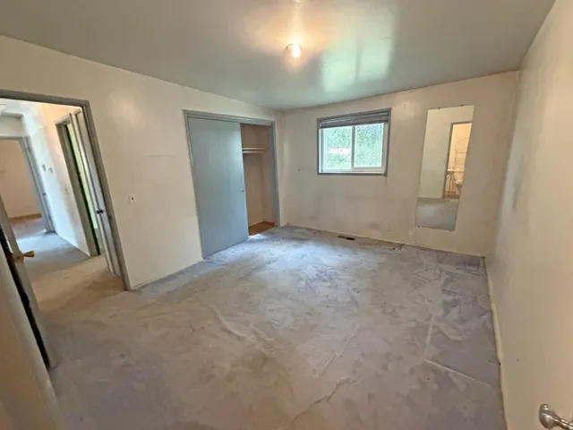 Recessed window, built-in closet with sliding doors, and overhead lighting