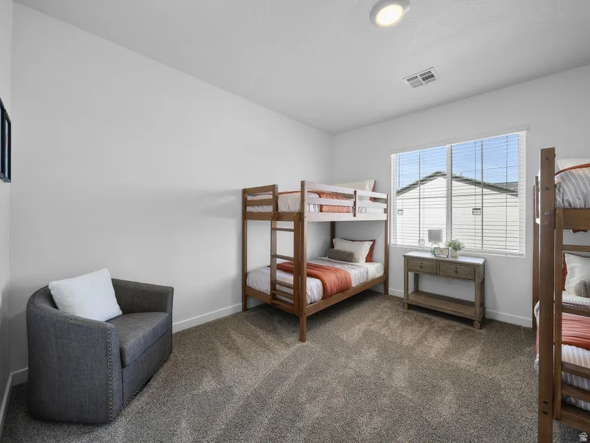 Recessed lighting, soft gray wall paint, window with blinds, and carpeted flooring