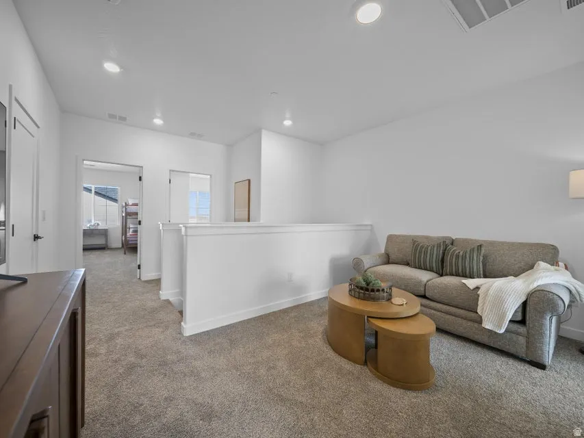 Carpeted flooring, recessed lighting, white interior doors, and white wall finishes