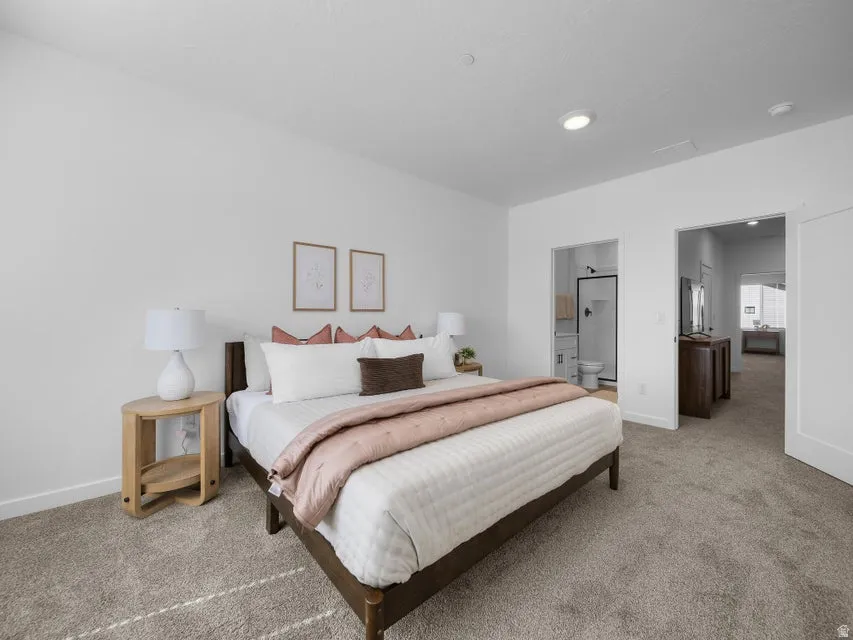 Spacious room with white walls, carpeted flooring, and recessed lighting