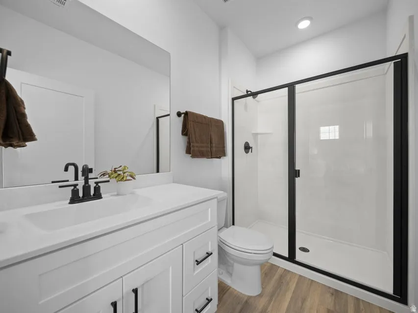White vanity with an integrated sink and matte black faucet, framed by a large wall mirror