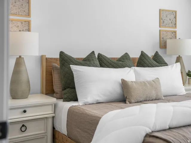 White painted walls, woven headboard, and built-in nightstands