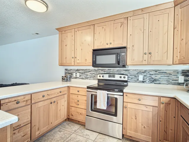Natural wood-finish cabinetry with silver hardware