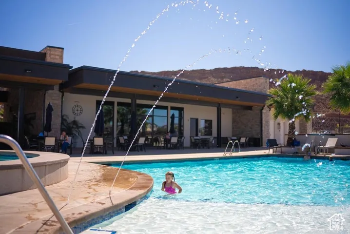 Expansive outdoor pool with integrated spa and water features