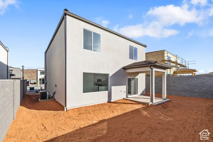Contemporary exterior stucco finish, covered patio with concrete flooring, dual pane windows, and a low-profile roof