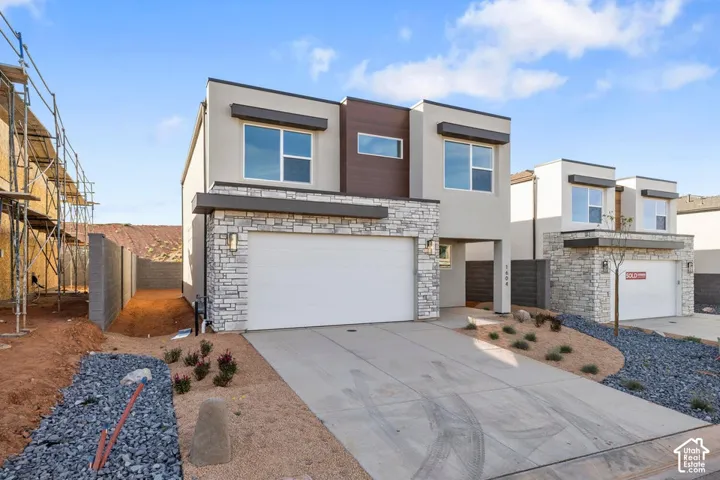 Contemporary exterior with stone veneer accents, wood-finish siding details, and a two-car garage