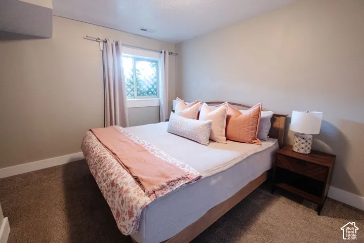 Carpeted room with a window, finished walls, and white trim