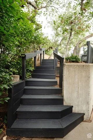 Wood-finish exterior stairs with black railings