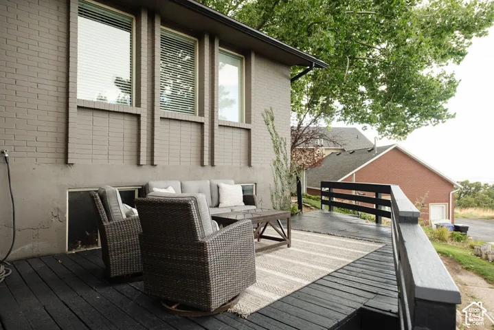 Spacious outdoor deck with dark wood-finish planking, featuring a dark wood-finish railing