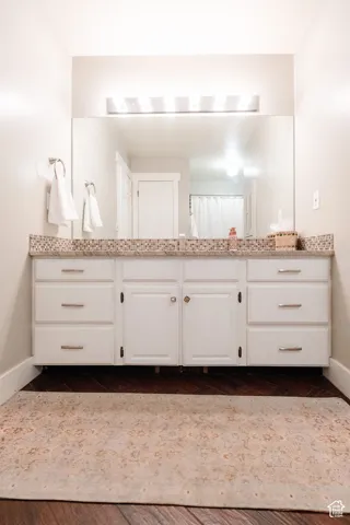 Expansive vanity with white cabinetry, ample storage, and a patterned tile backsplash