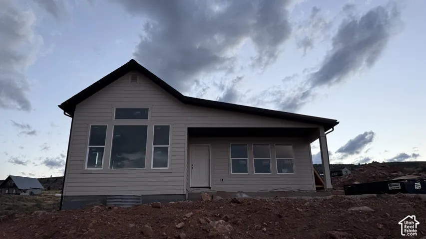 Siding exterior with a covered porch and multiple window configurations