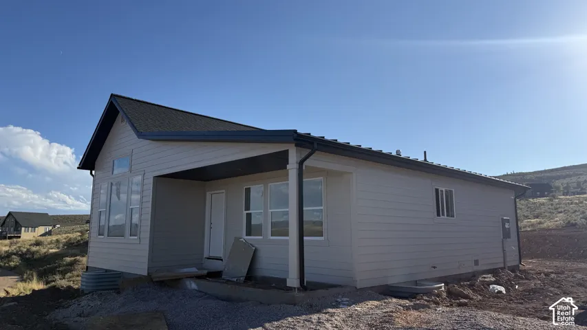 Light-toned horizontal siding with a covered entry