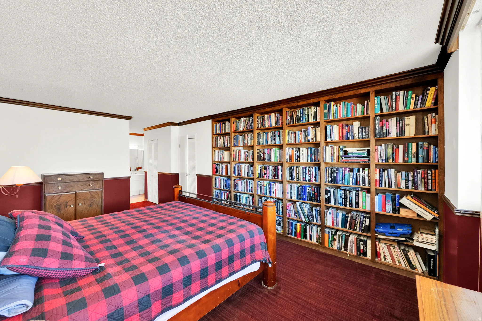 Full-wall built-in wood bookshelves with extensive storage