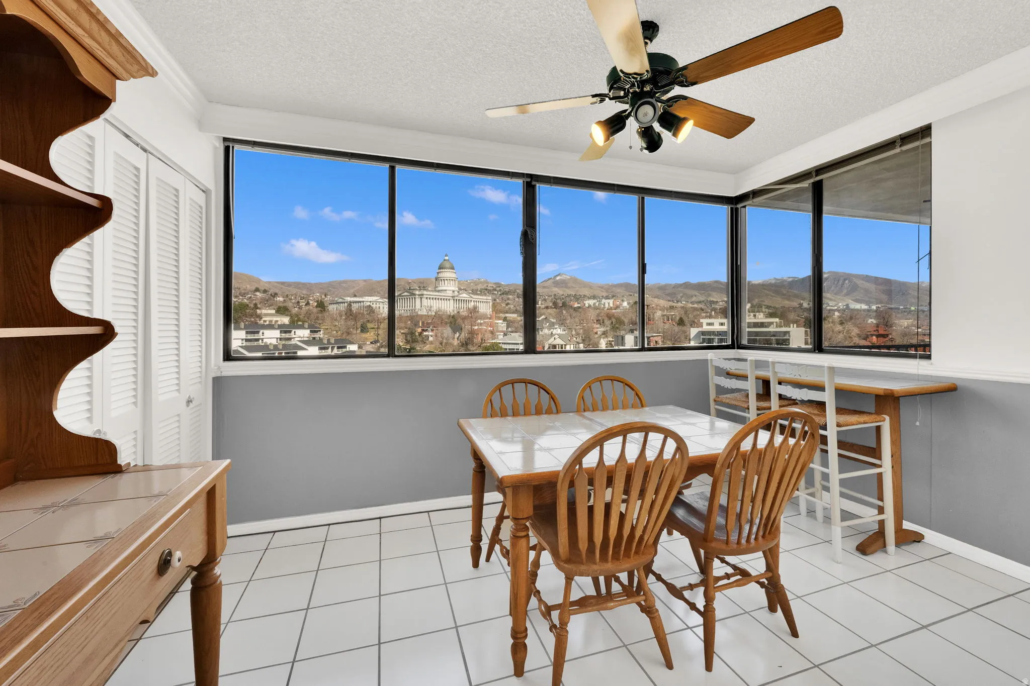 Expansive windows showcasing a city and mountain backdrop
