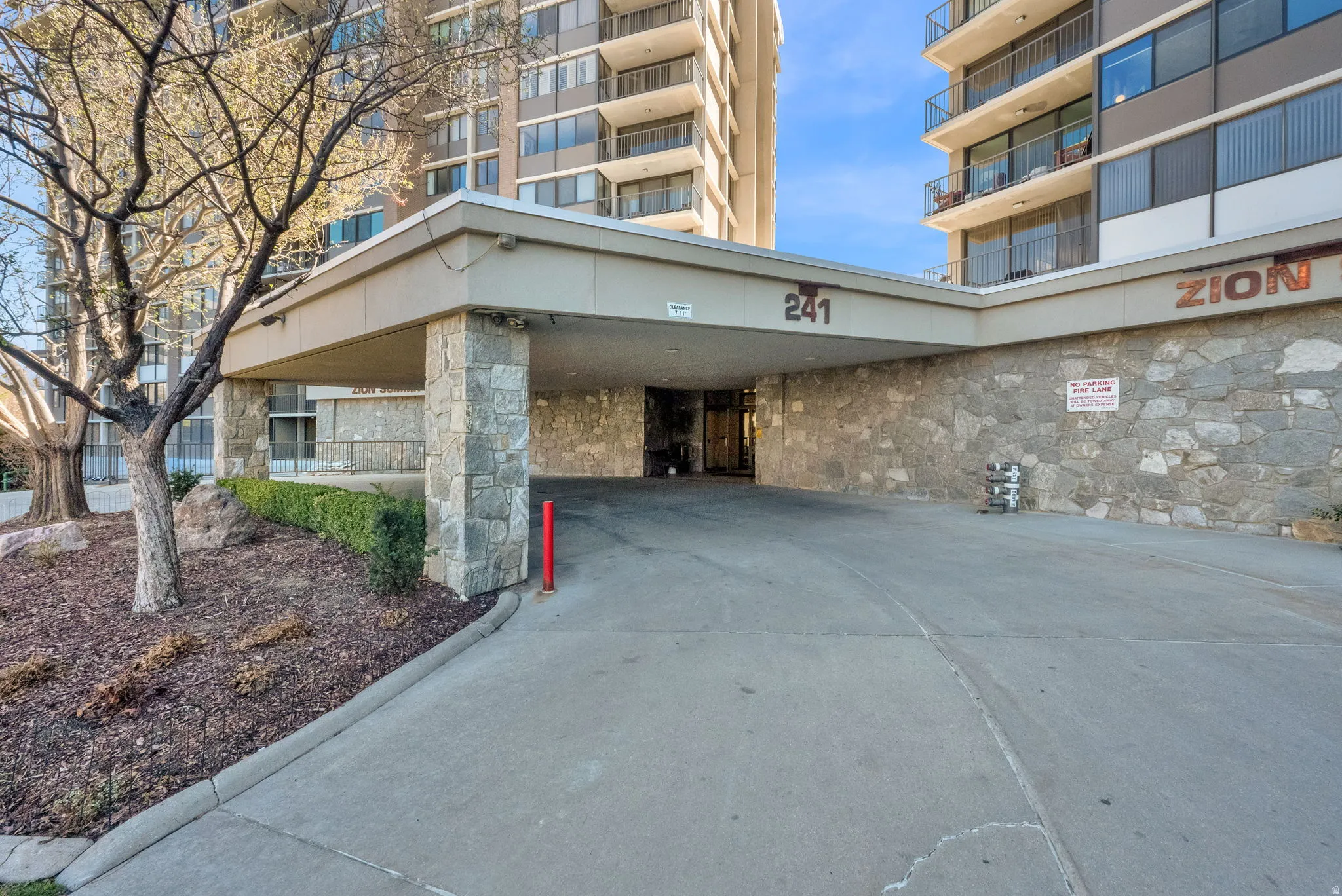 Covered entry with stone-clad pillars and wall detailing