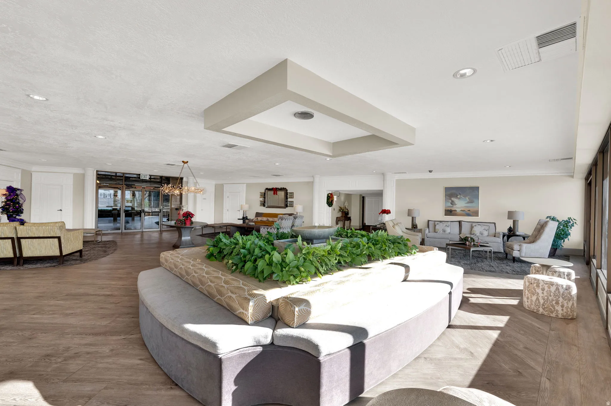 Spacious common area featuring wood-finish flooring, recessed lighting, and a decorative ceiling fixture