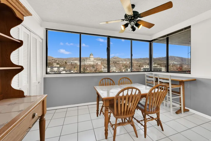 Expansive windows showcasing a city and mountain backdrop