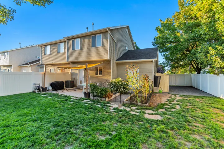 Private backyard, fully fenced with side yard and garden